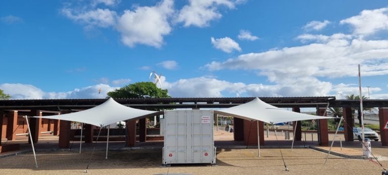 Two White Custom Stretch Tent Canopies extending from both sides of a standard shipping Container