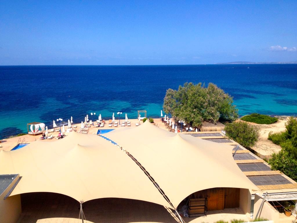 Beige stretch tents covering a coastal terrace overlooking the sea in Spain
