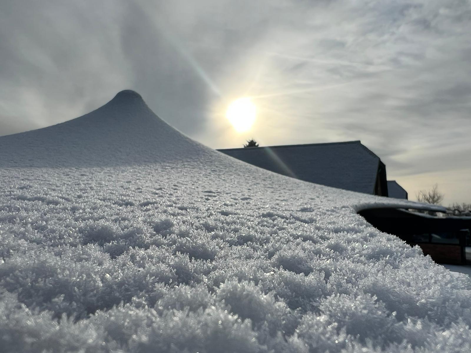 Close view of snow resting on the tensioned fabric of an RHI stretch tent