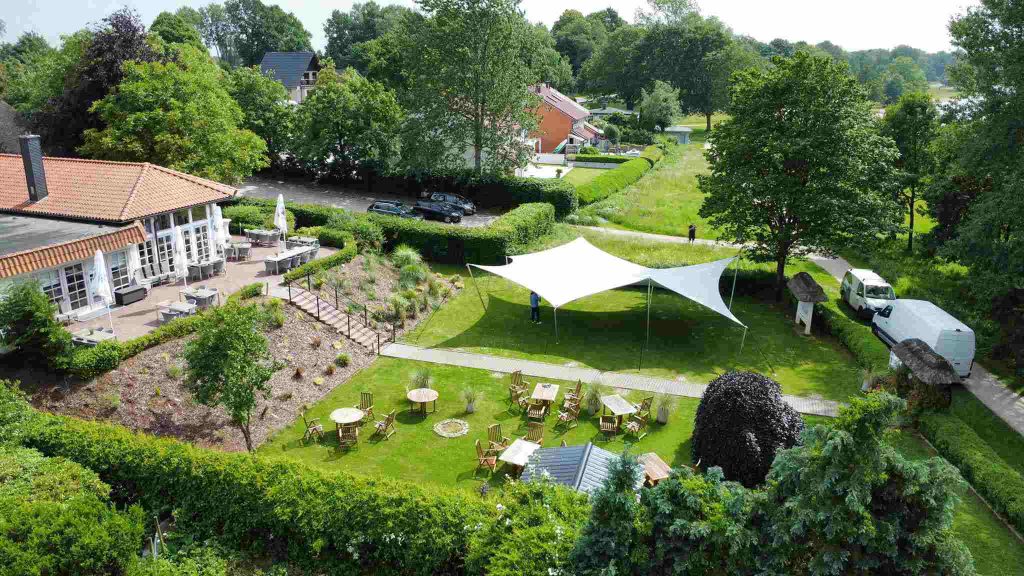 Aerial view of a platinum grey RHI Hypar stretch tent installed on a landscaped event venue lawn in Germany