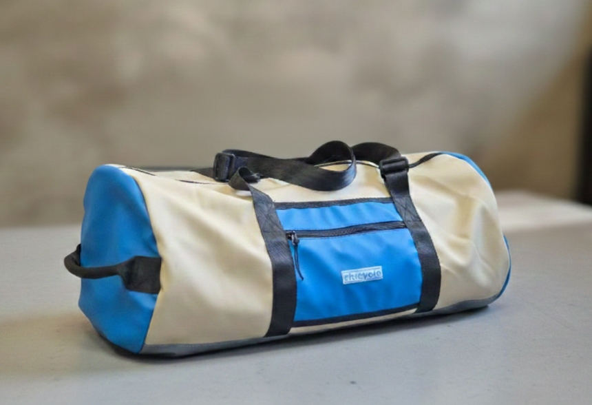 Product image showing a blue and beige duffel bag created from recovered RHI stretch tent material