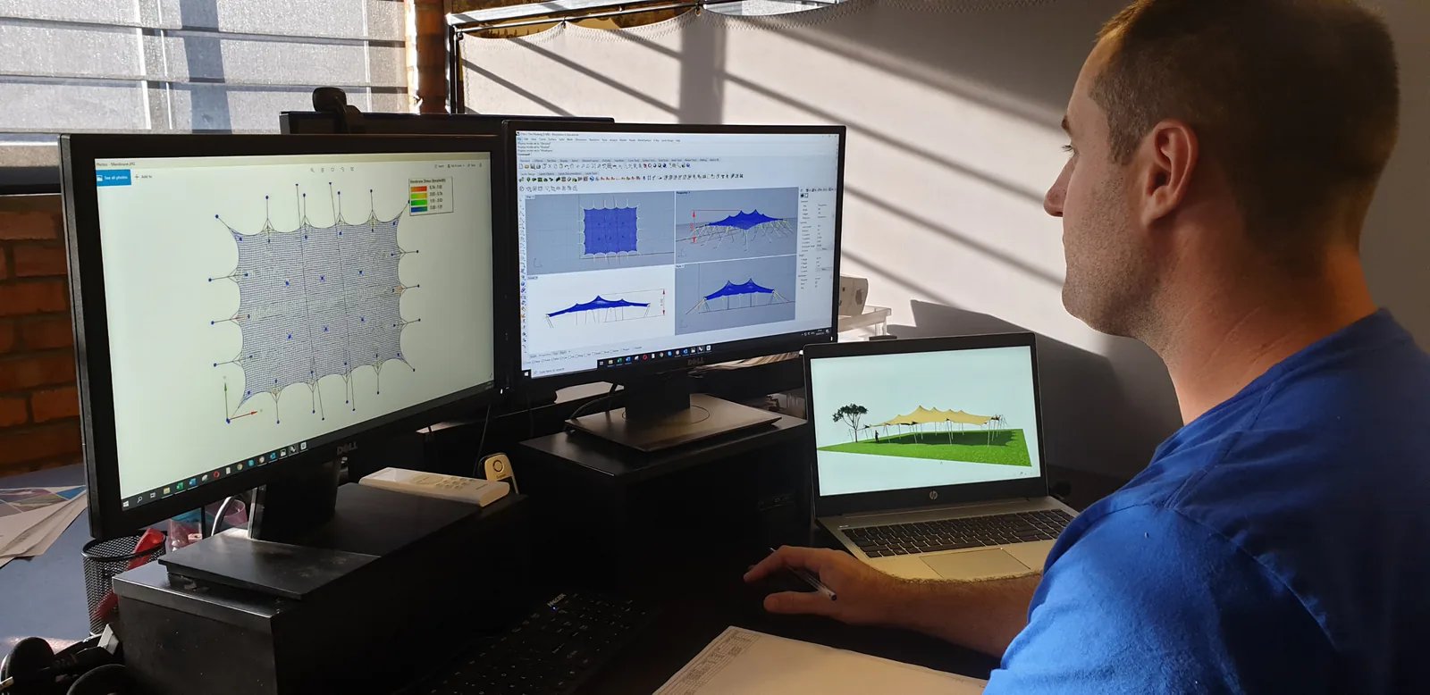 RHI designer reviewing a custom stretch tent model and engineering analysis