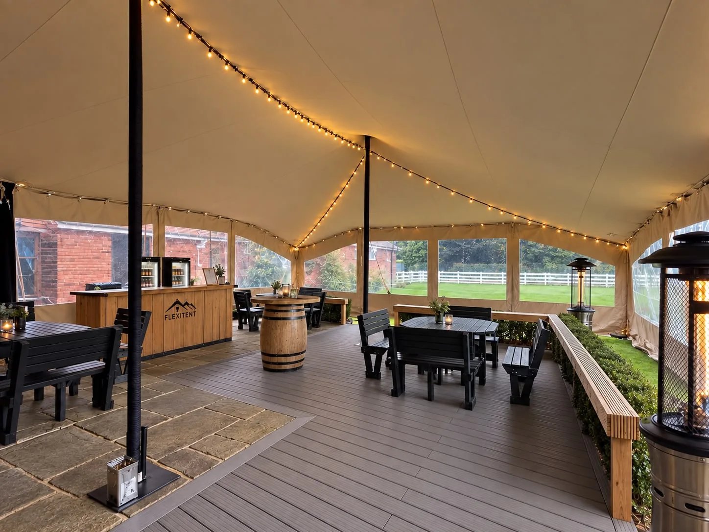 Heated stretch tent interior with clear wall panels and ambient lighting