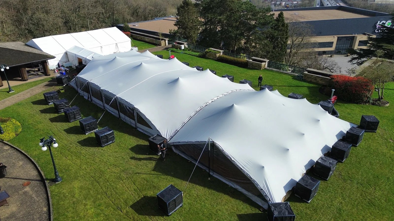Aerial view of linked stretch tents enclosed with modular walling and a door