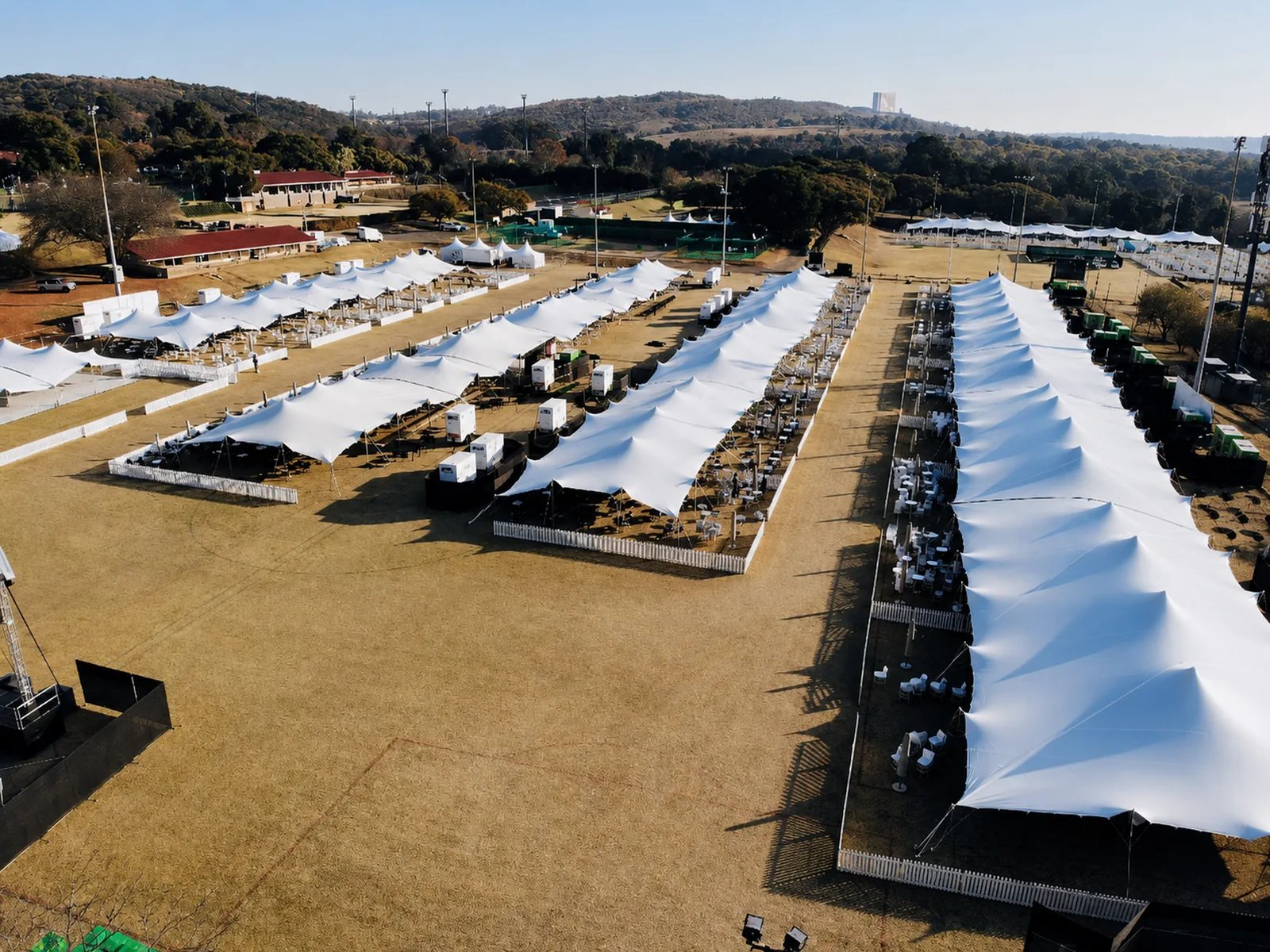 Aerial view of rows of modular linked stretch tents across an event site