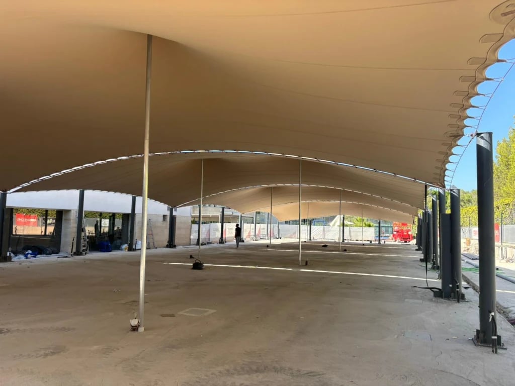 Broad stretch roof above an open training floor — Linked Stretch Tents for an Outdoor Gym in Mallorca