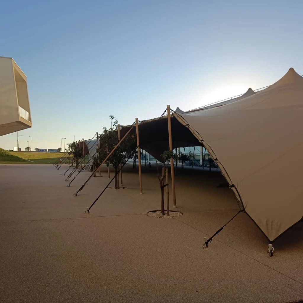stretch tent sections within a contemporary campus courtyard — 630 m² Linked Stretch Tents at Nova SBE in Portugal