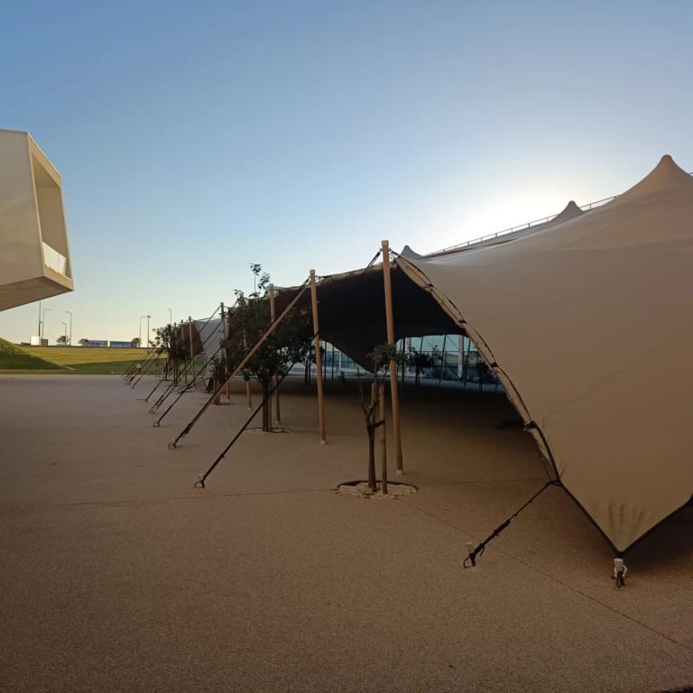 stretch tent sections within a contemporary campus courtyard — 630 m² Linked Stretch Tents at Nova SBE in Portugal