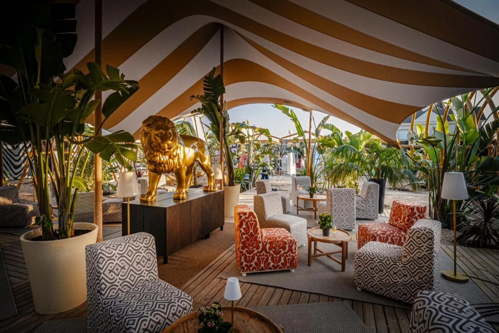 Striped stretch tent above a planted outdoor lounge — Striped Stretch Tent for Safari Beach Club in Spain