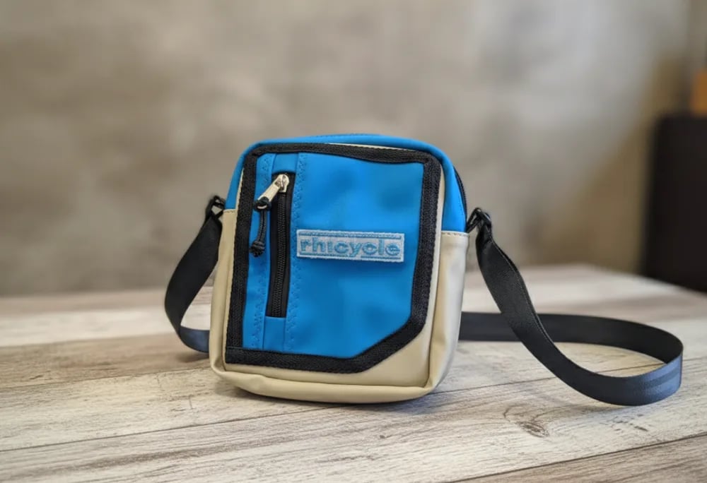 Blue and cream RHICYCLE shoulder bag made from upcycled tent material