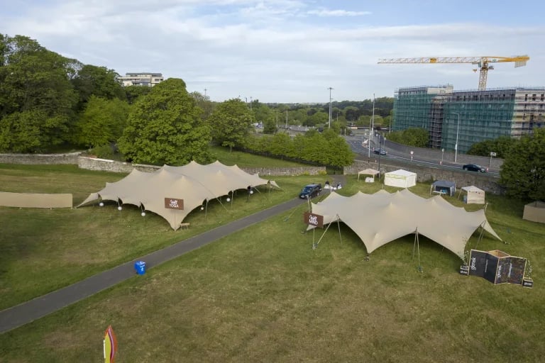 Vue aérienne des différentes zones d'animation d'une grande « tentes stretch » RHI réparties sur le site d'un festival public