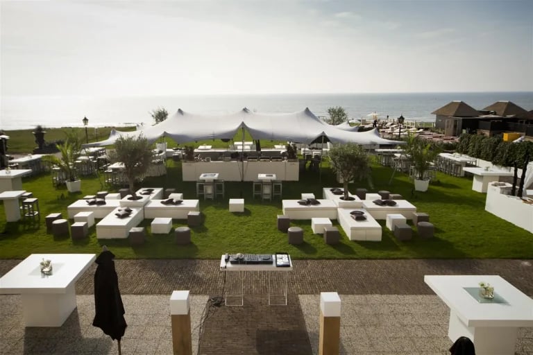 Vue aérienne de l'agencement d'une réception en bord de mer, avec une tente « Flextent » de RHI, aménagée pour un mariage ou une réception en plein air en Allemagne